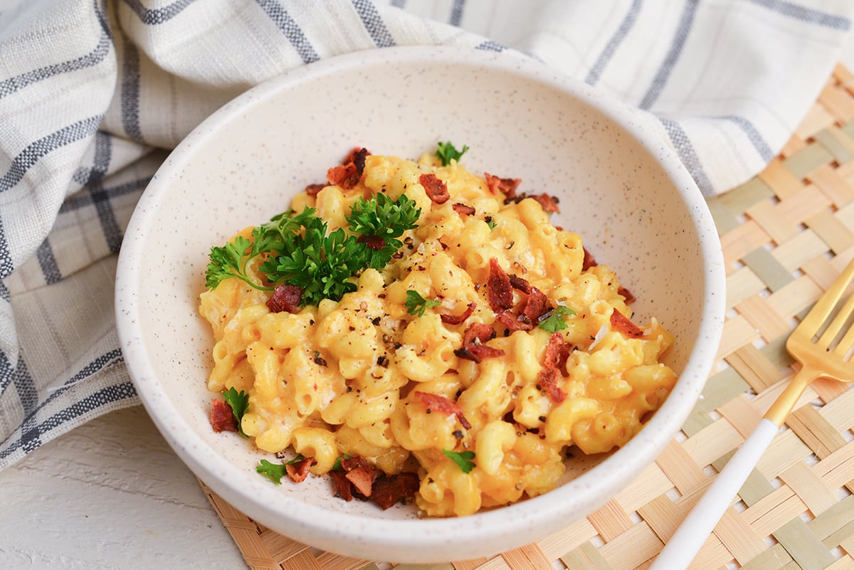 angled shot of bowl of mac and cheese with bacon