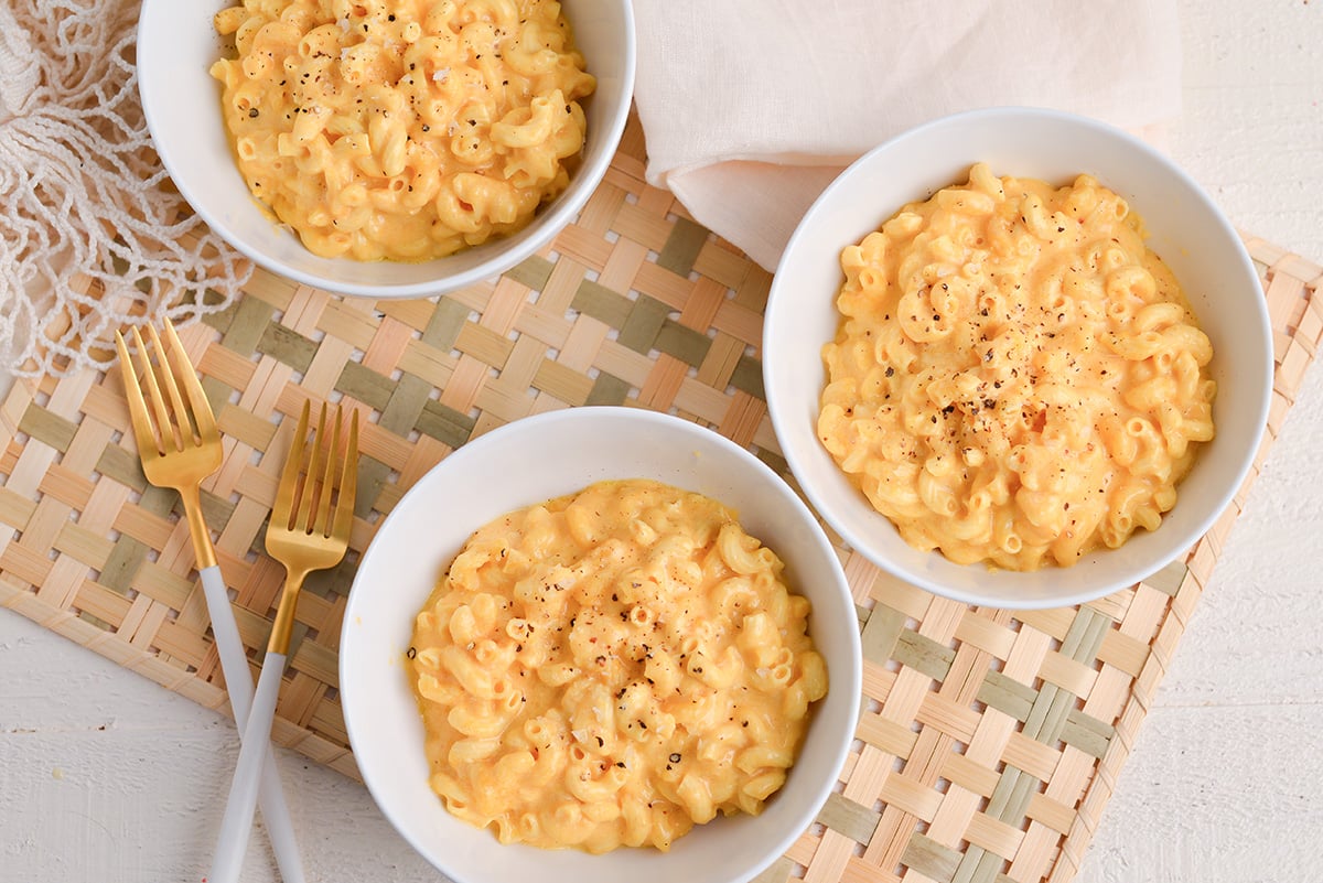 overhead shot of three bowl of crock pot mac and cheese