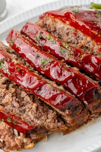 angled shot of sliced slow cooker meatloaf on a platter