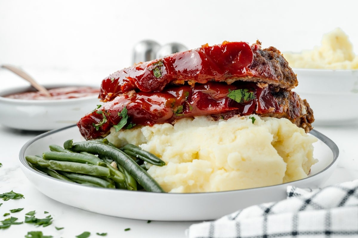 straight on shot of meatloaf slices on mashed potatoes