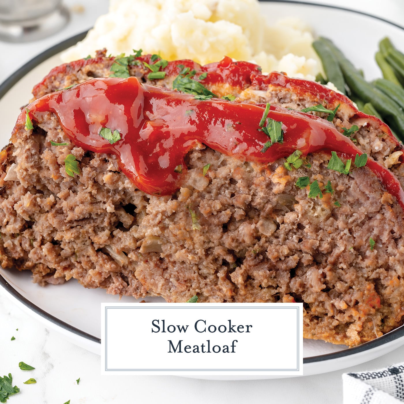 angled shot of sliced slow cooker meatloaf with text overlay for facebook