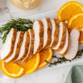 overhead shot of sliced slow cooker turkey breast on a platter