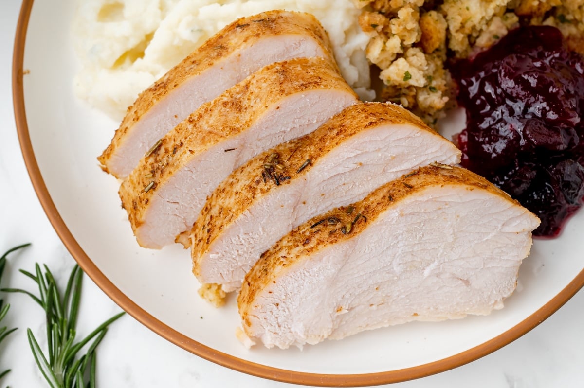 angled close up shot of sliced slow cooker turkey breast