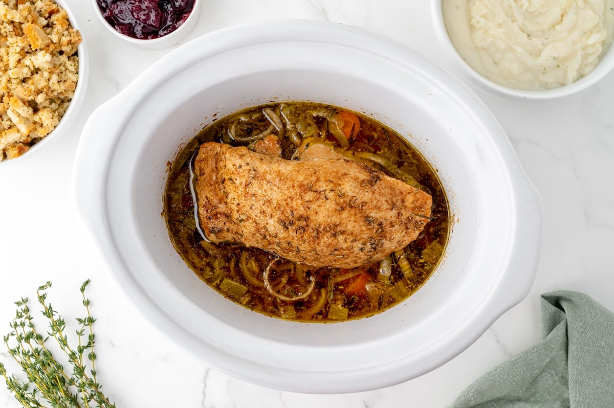 overhead shot of turkey breast cooking in slow cooker