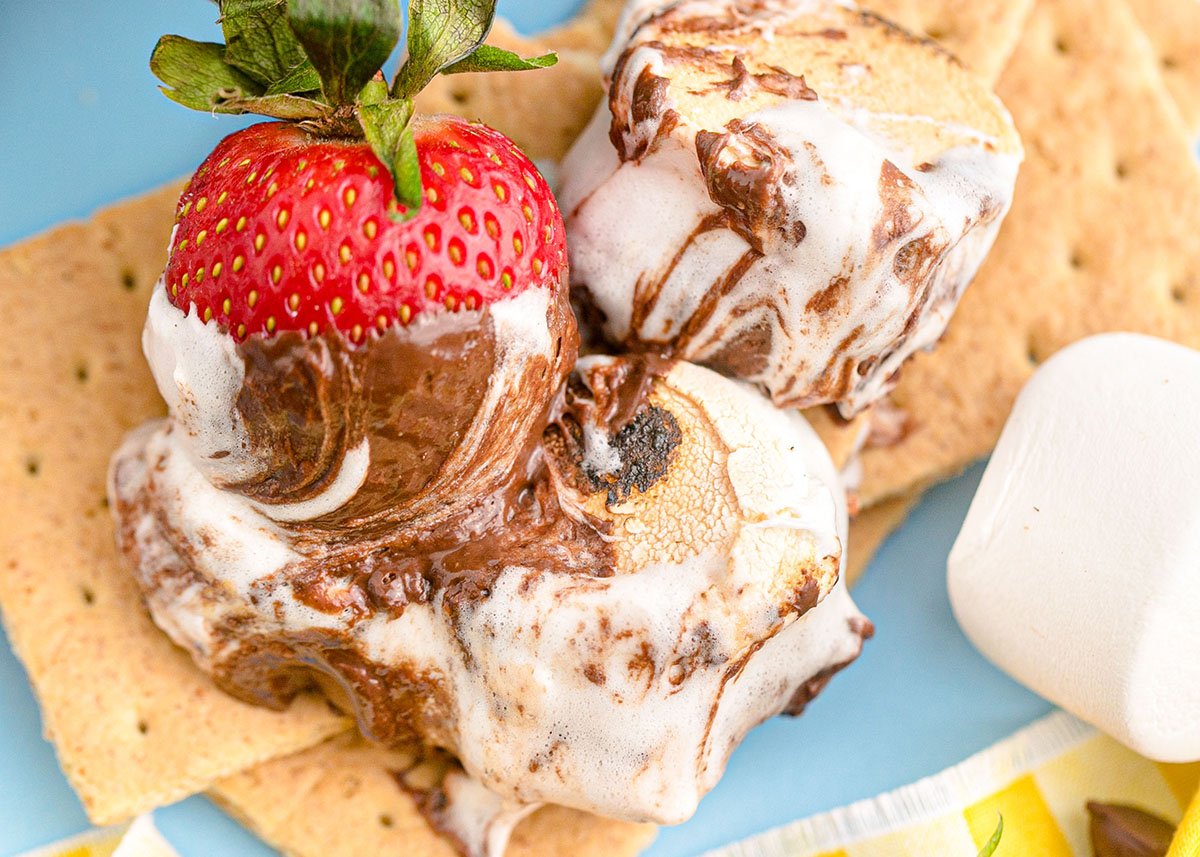 strawberry on a graham cracker with marshmallow and chocolate