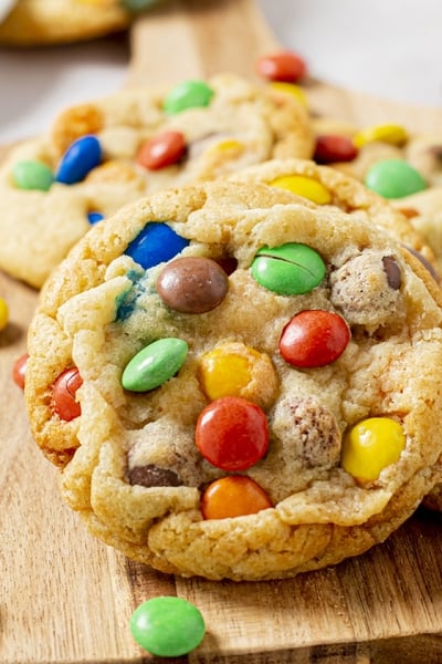 angled shot of soft m&m cookies on board