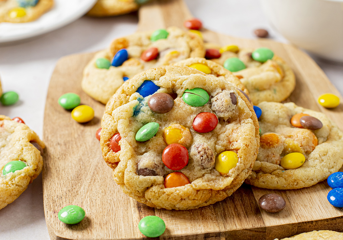 angled shot of soft m&m cookies on board