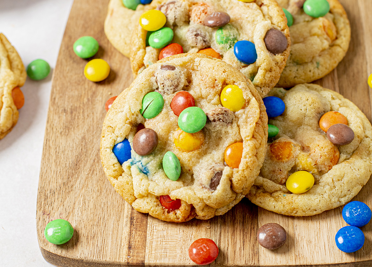 close up angled shot of m&m cookies on board