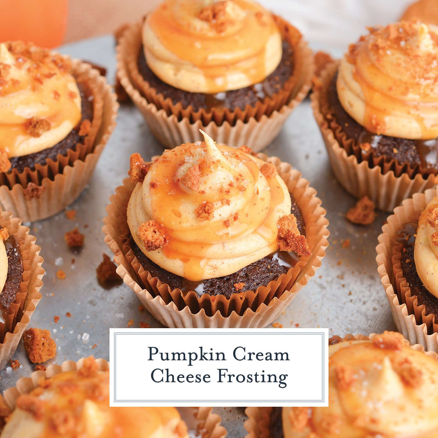 angled shot of chocolate cupcakes topped with pumpkin cream cheese frosting with text overlay for facebook