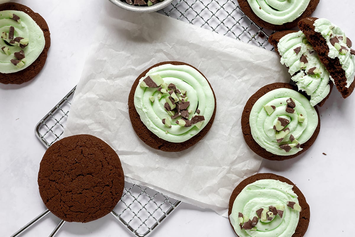 close up of a green frosted cookie with andes mint topping