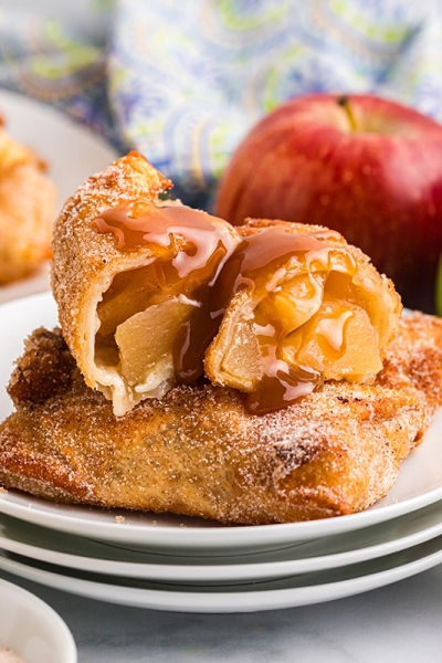 straight on shot of apple pie egg roll cut in half on plate