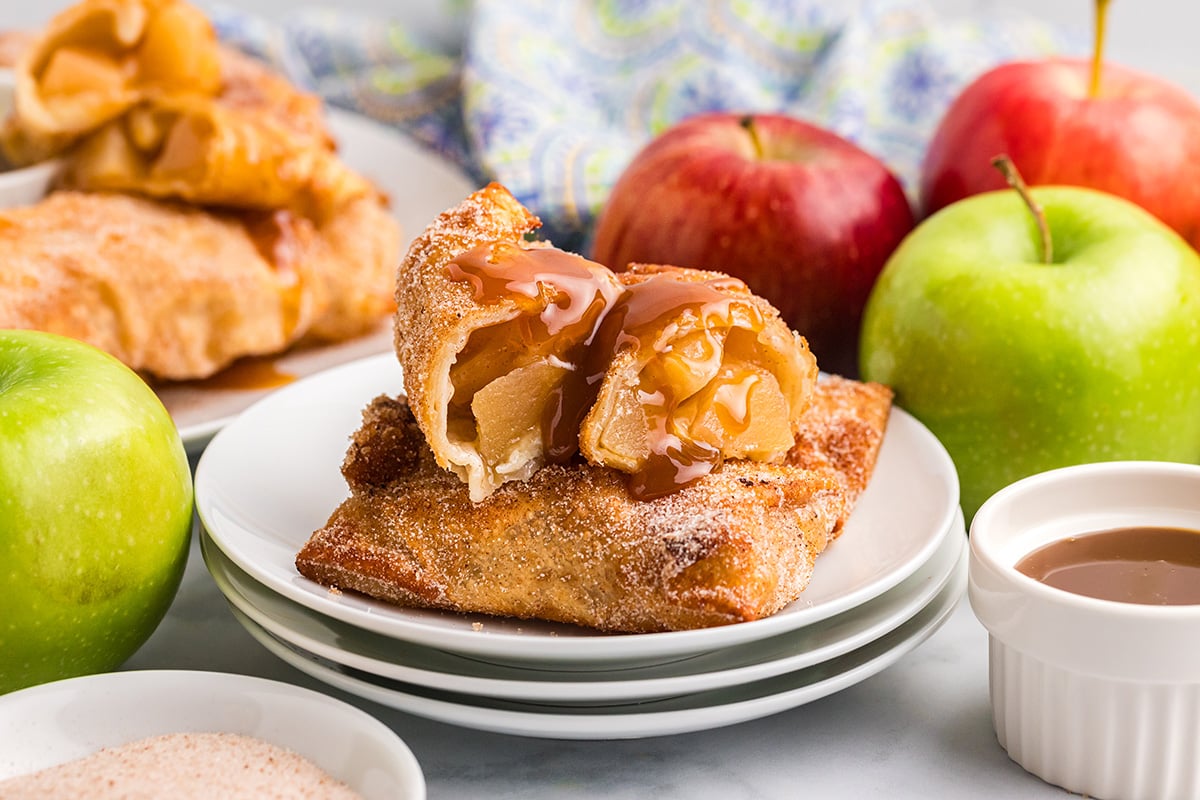 straight on shot of apple pie egg roll cut in half on plate