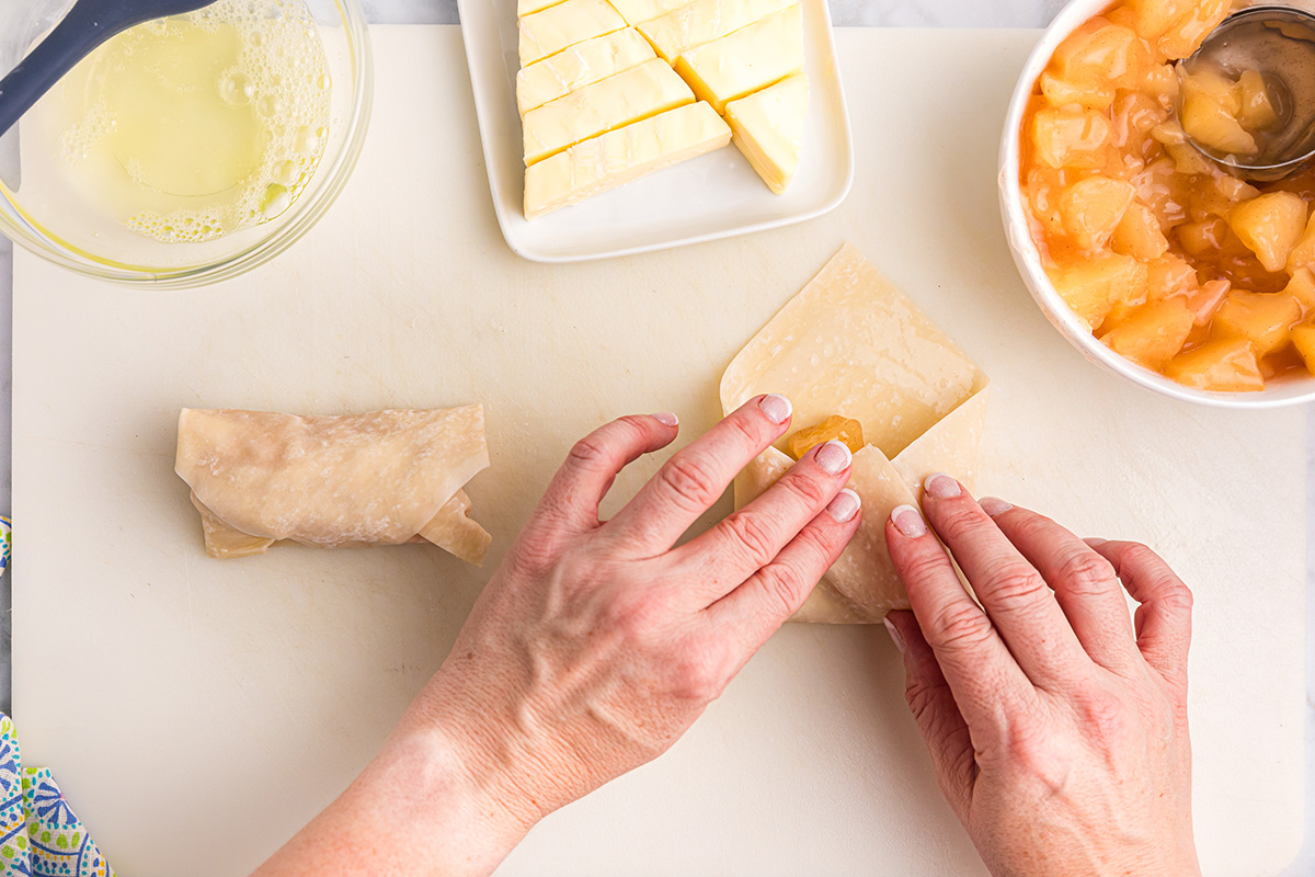 hand rolling egg rolls
