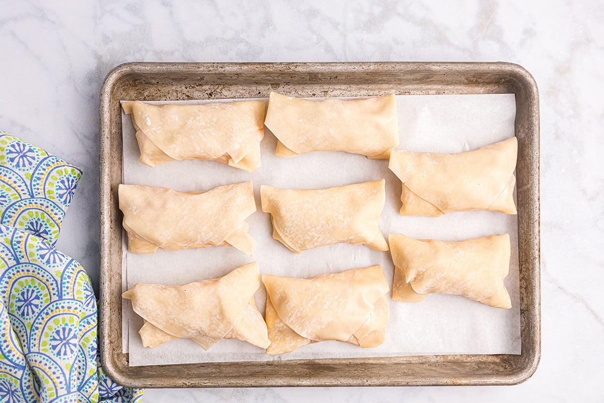 raw egg rolls on sheet pan