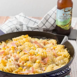 angled shot of skillet of creamy ham pasta