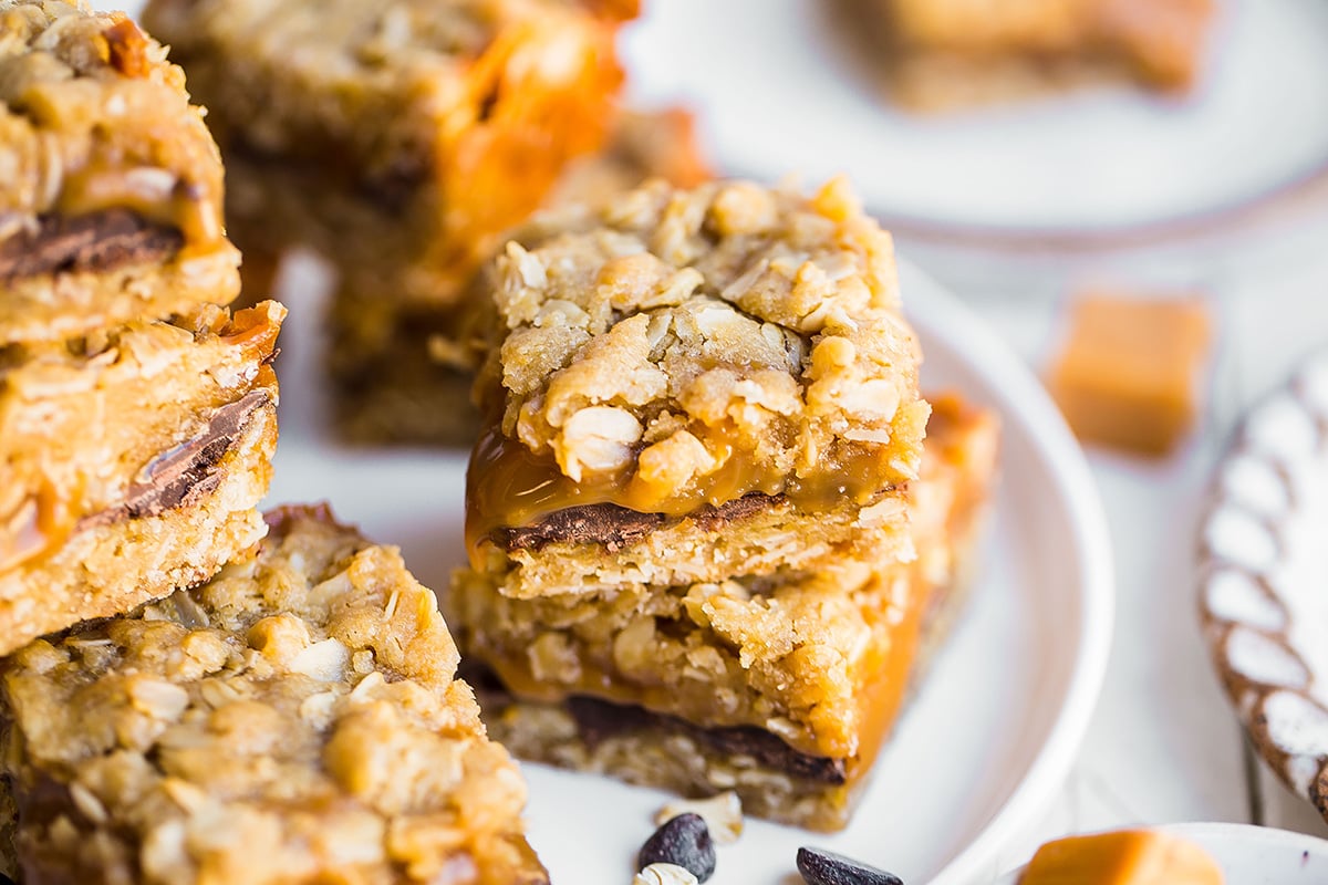 angle view of carmelita bars on a white serving plate