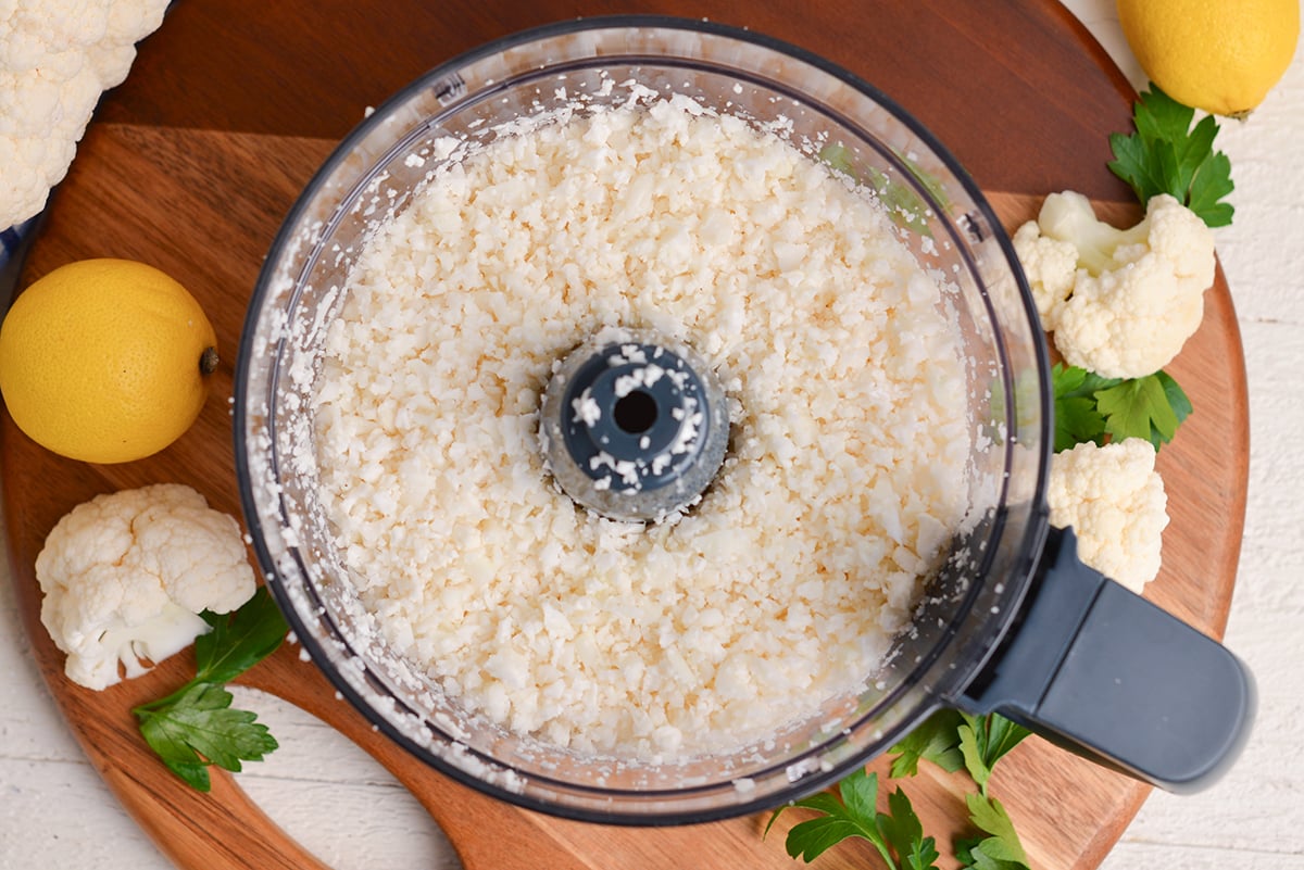 overhead shot of cauliflower in food processor