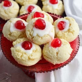 cherry cheesecake cookies piled on a red serving platter