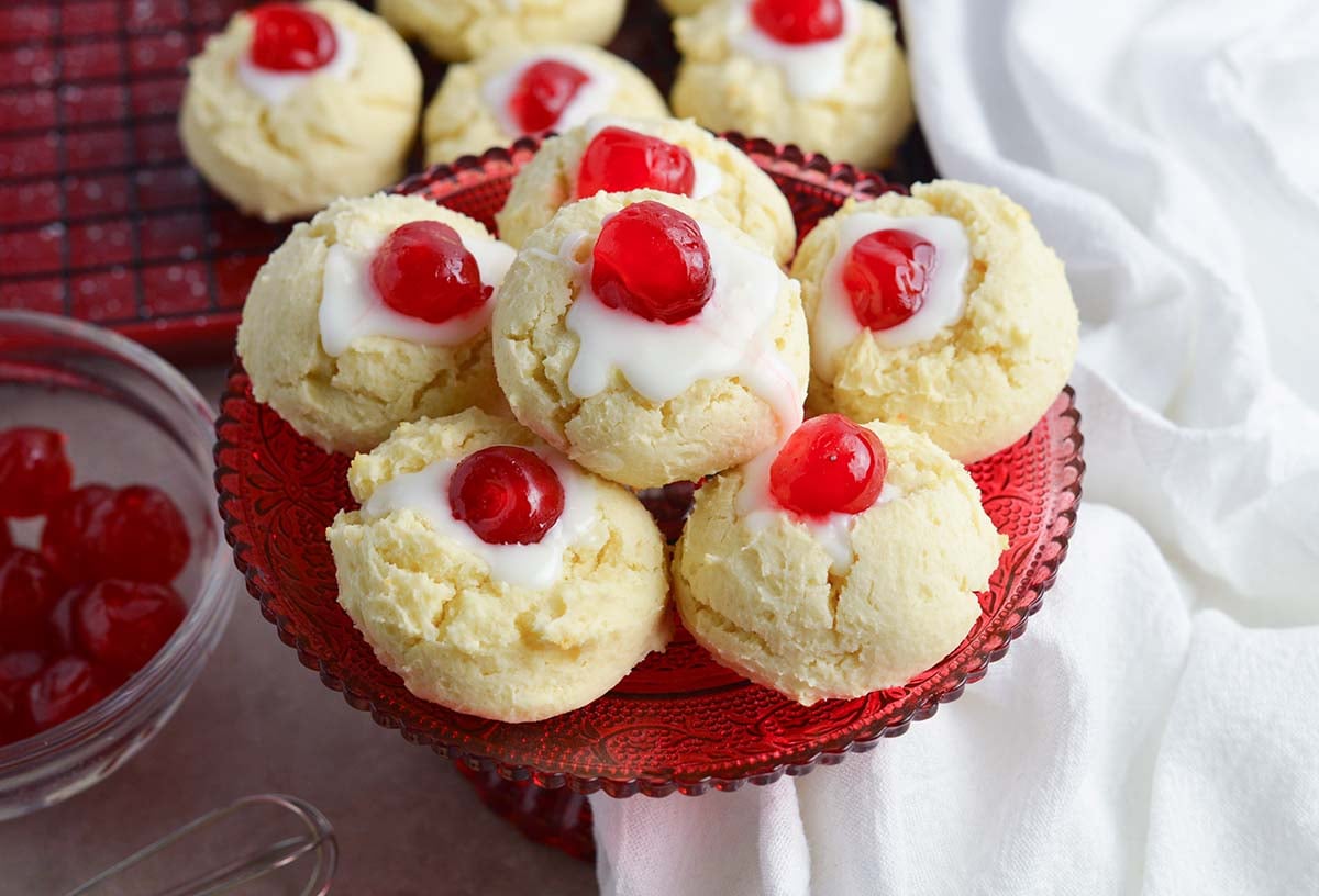 cherry cheesecake cookies piled on a red serving platter