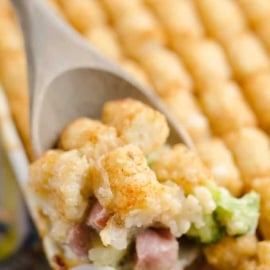 angled shot of serving spoon in tater tot casserole