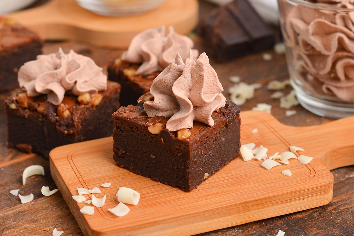 close up of brownie square with homemade chocolate whipped cream topping