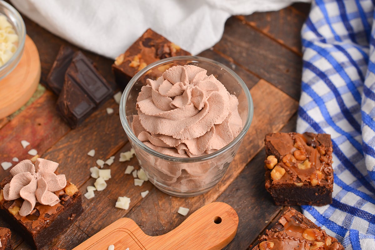 angle cup of whipped cream with turtle brownies and blue linen