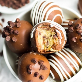 bowl of cookie dough truffles with a bite taken out