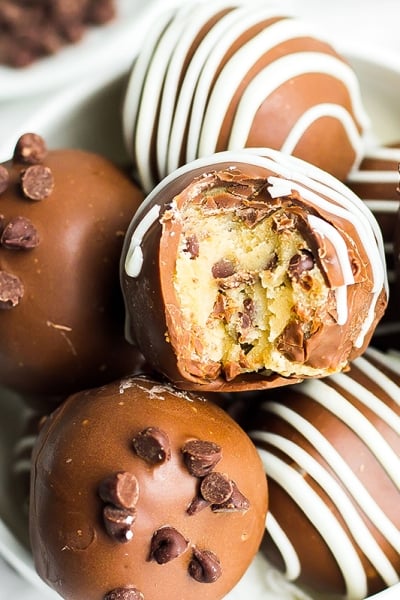 bowl of cookie dough truffles with a bite taken out