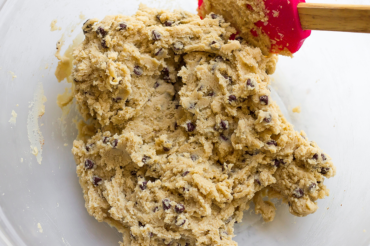 making cookie dough for truffles in a glass mixing bowl