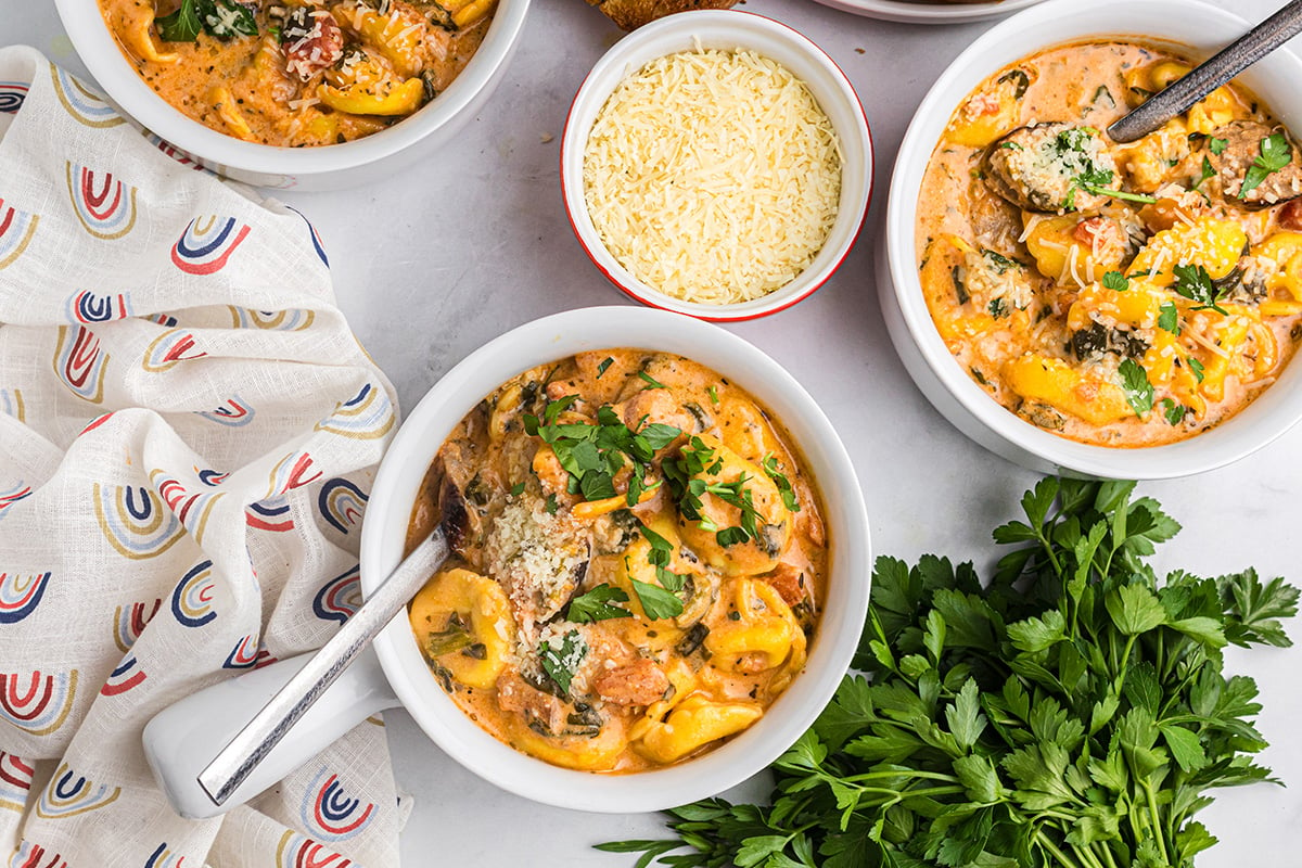 overhead shot of two bowl of creamy tortellini soup