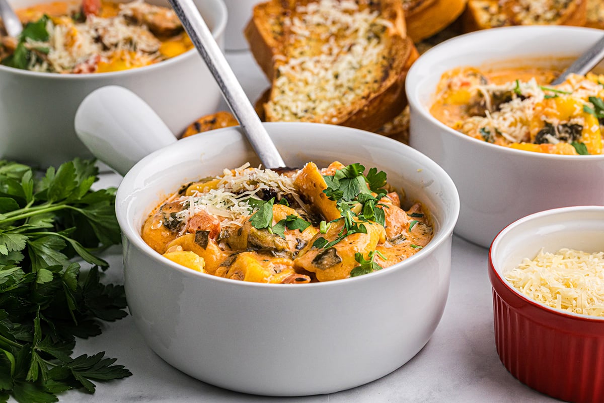 angled shot of bowl of creamy tortellini soup