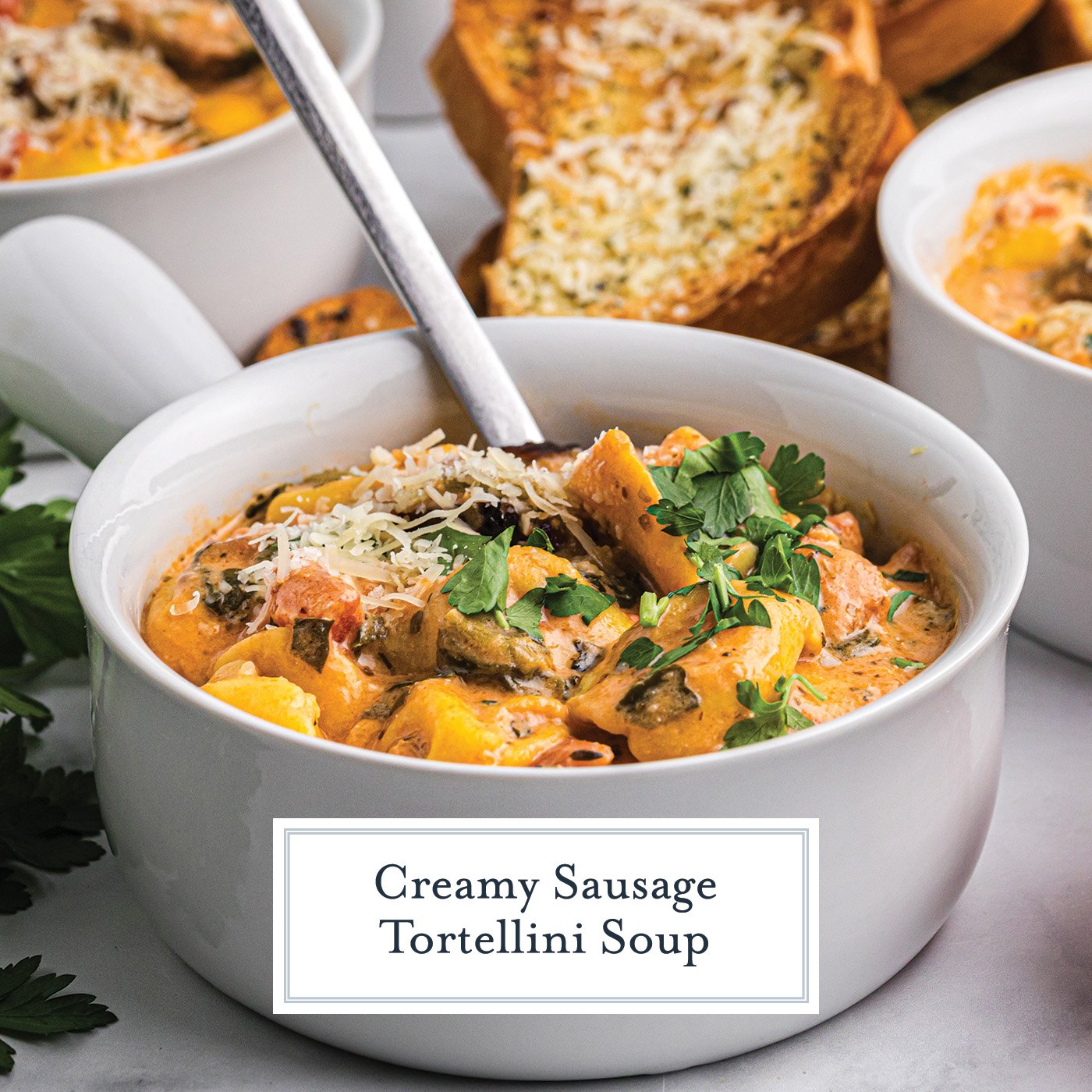 angled shot of bowl of tortellini and sausage soup with text overlay for facebook