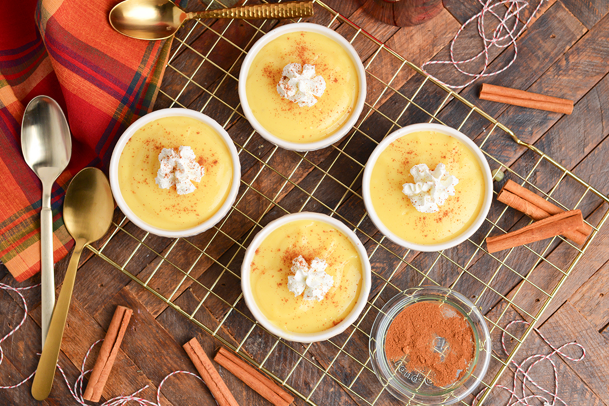 overhead shot of eggnog pudding in cups with whipped cream