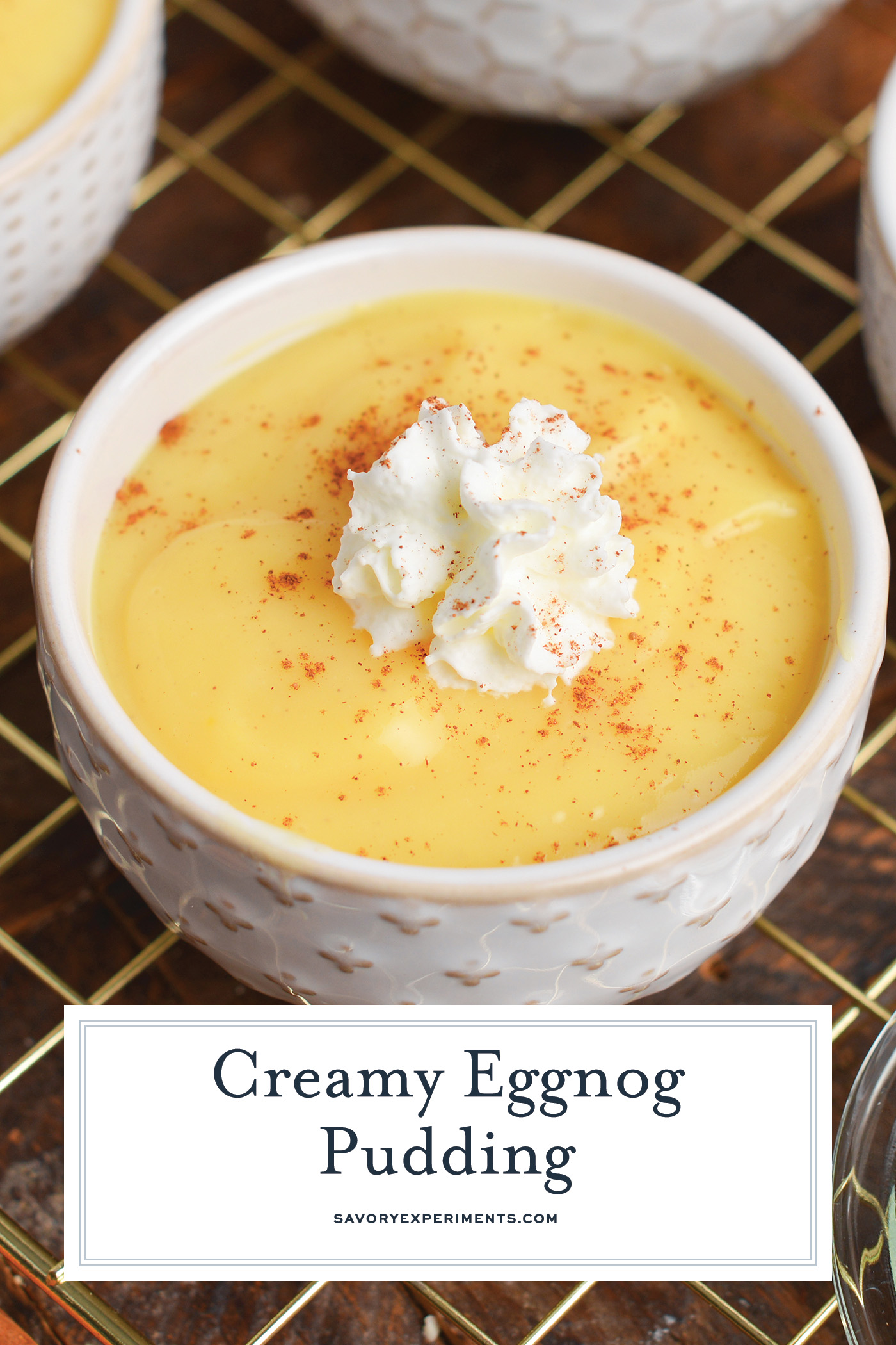 angled shot of eggnog pudding with text overlay for pinterest