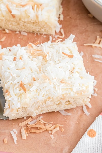 spatula holding one square of coconut bars