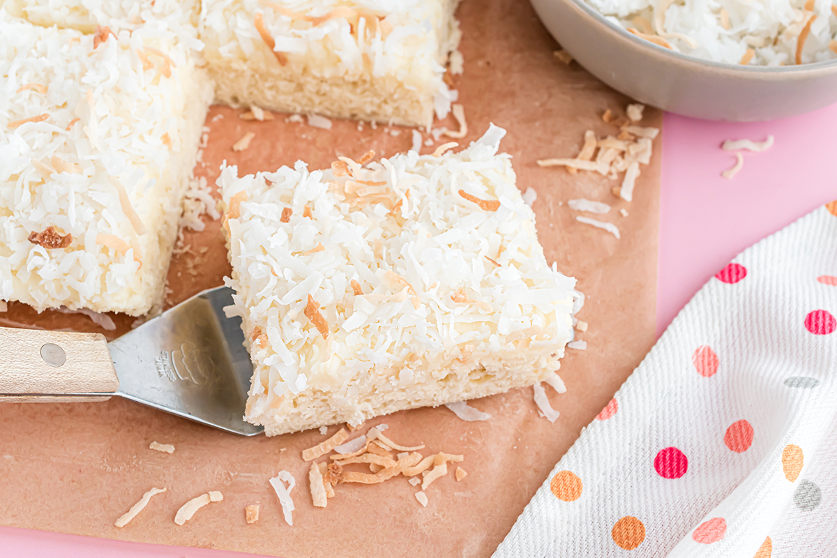 spatula holding one square of coconut bars