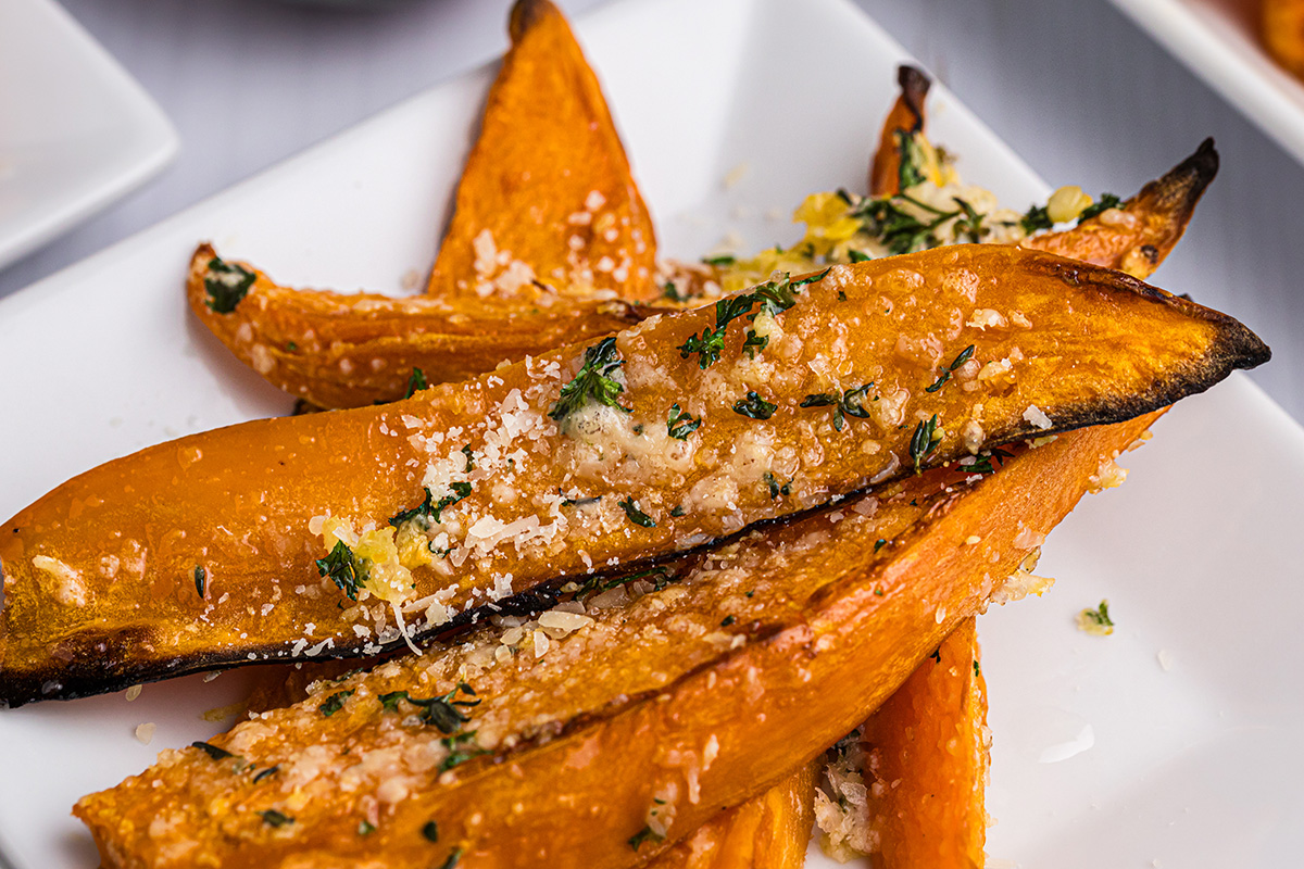 close up angled shot of sweet potato fries on plate