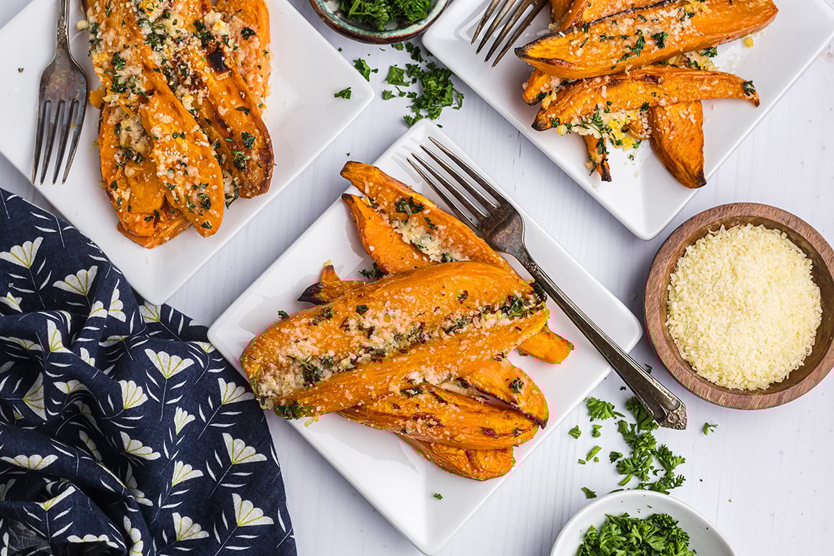 overhead shot of three plates of baked sweet potato fries