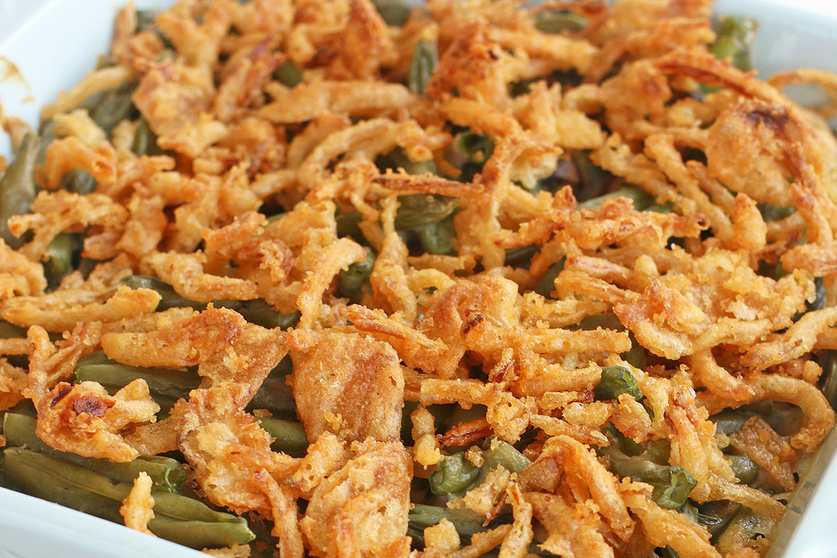 A close up of green bean casserole with crunchy onion topping