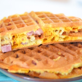 angled shot of ham and cheese waffles on plate