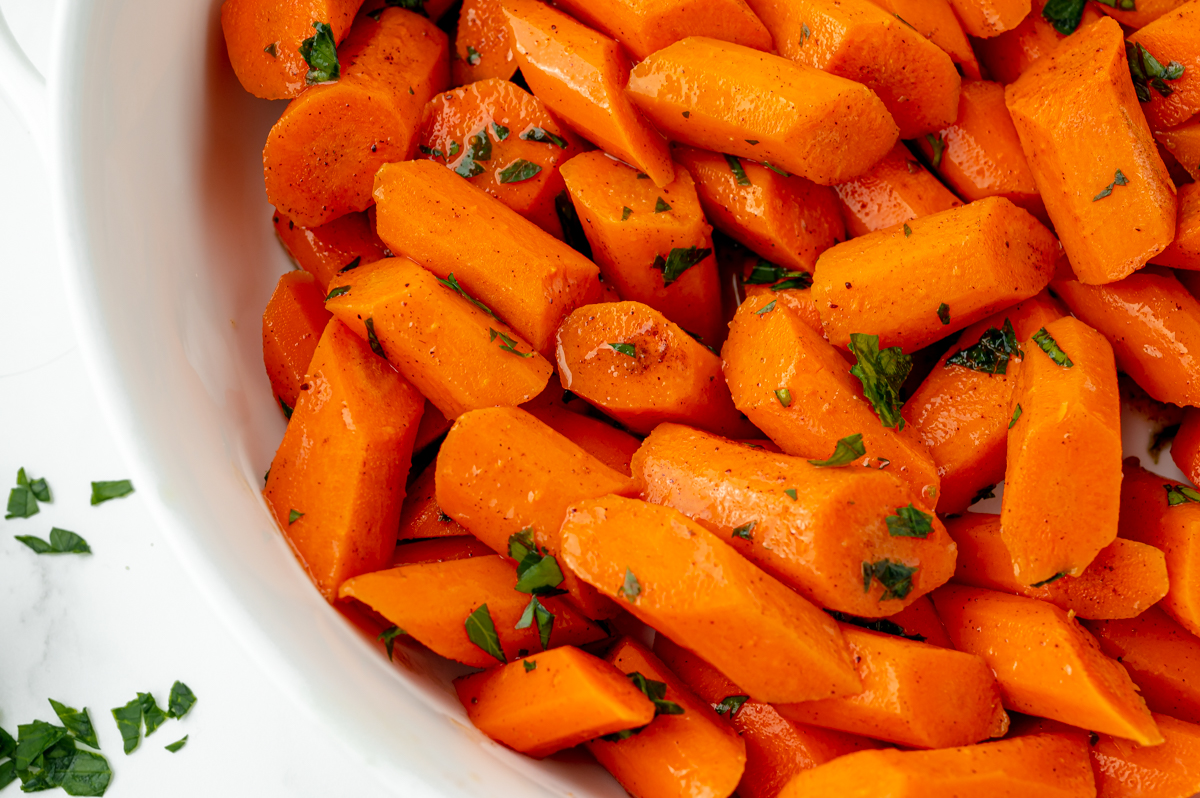 overhead half shot of honey glazed carrots in bowl