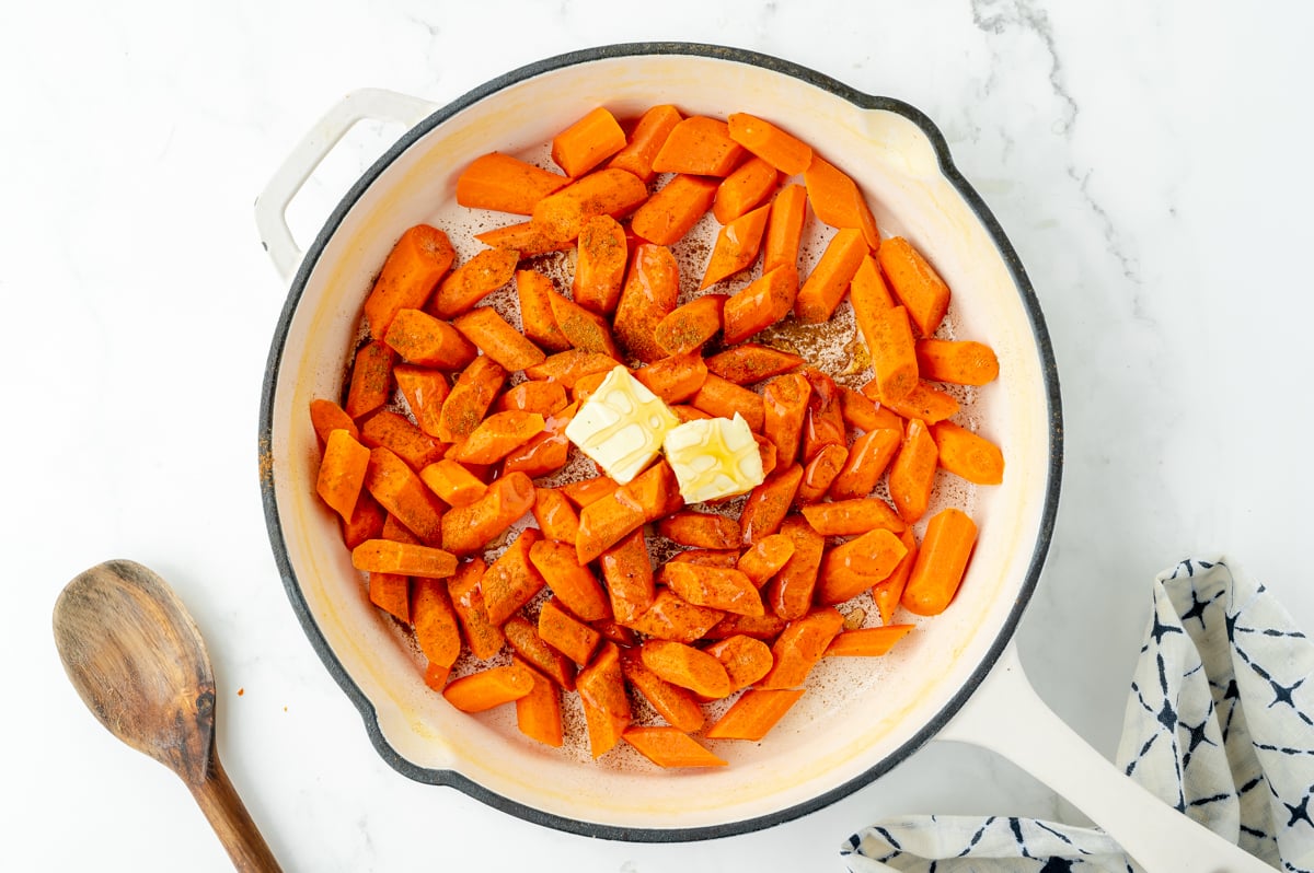 overhead shot of carrots in pan with butter and honey