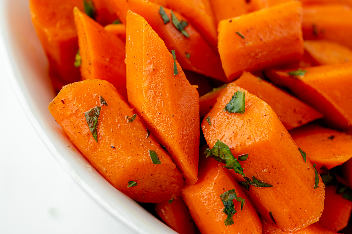 close up shot of honey glazed carrots in bowl