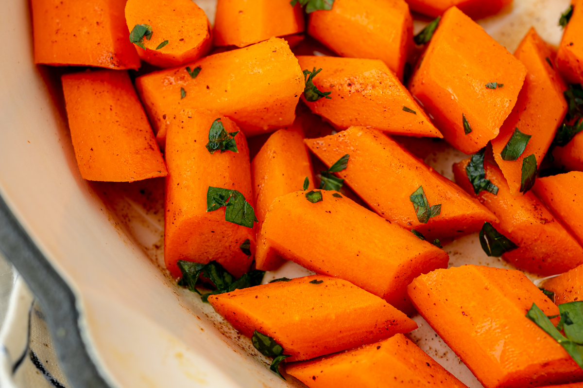 close up angled shot of honey glazed carrots in pan