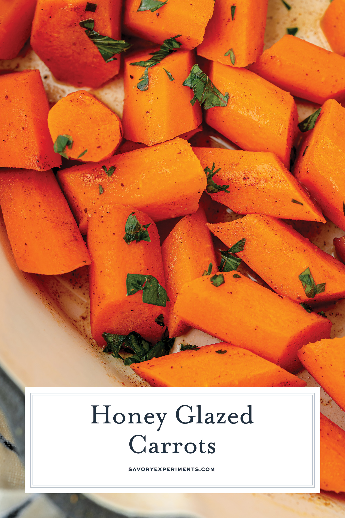 close up overhead shot of honey glazed carrots in pan with text overlay for pinterest