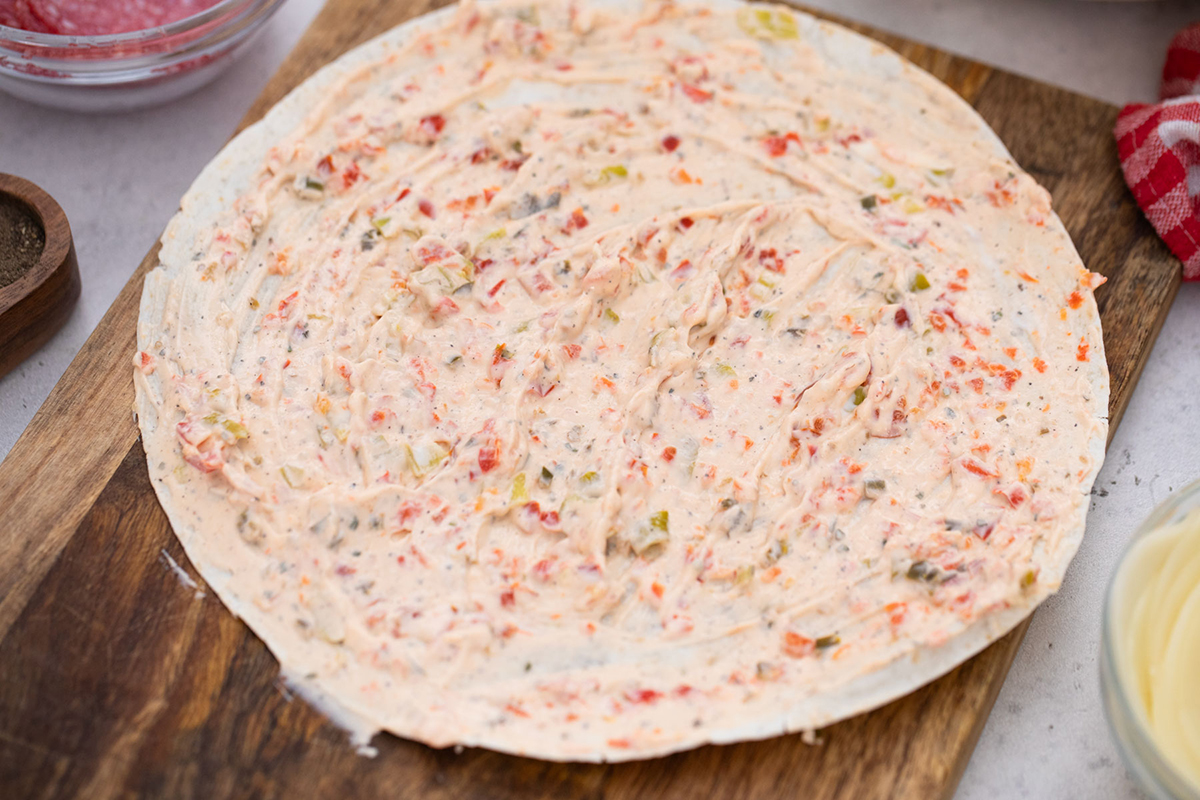 red pepper spread onto tortilla