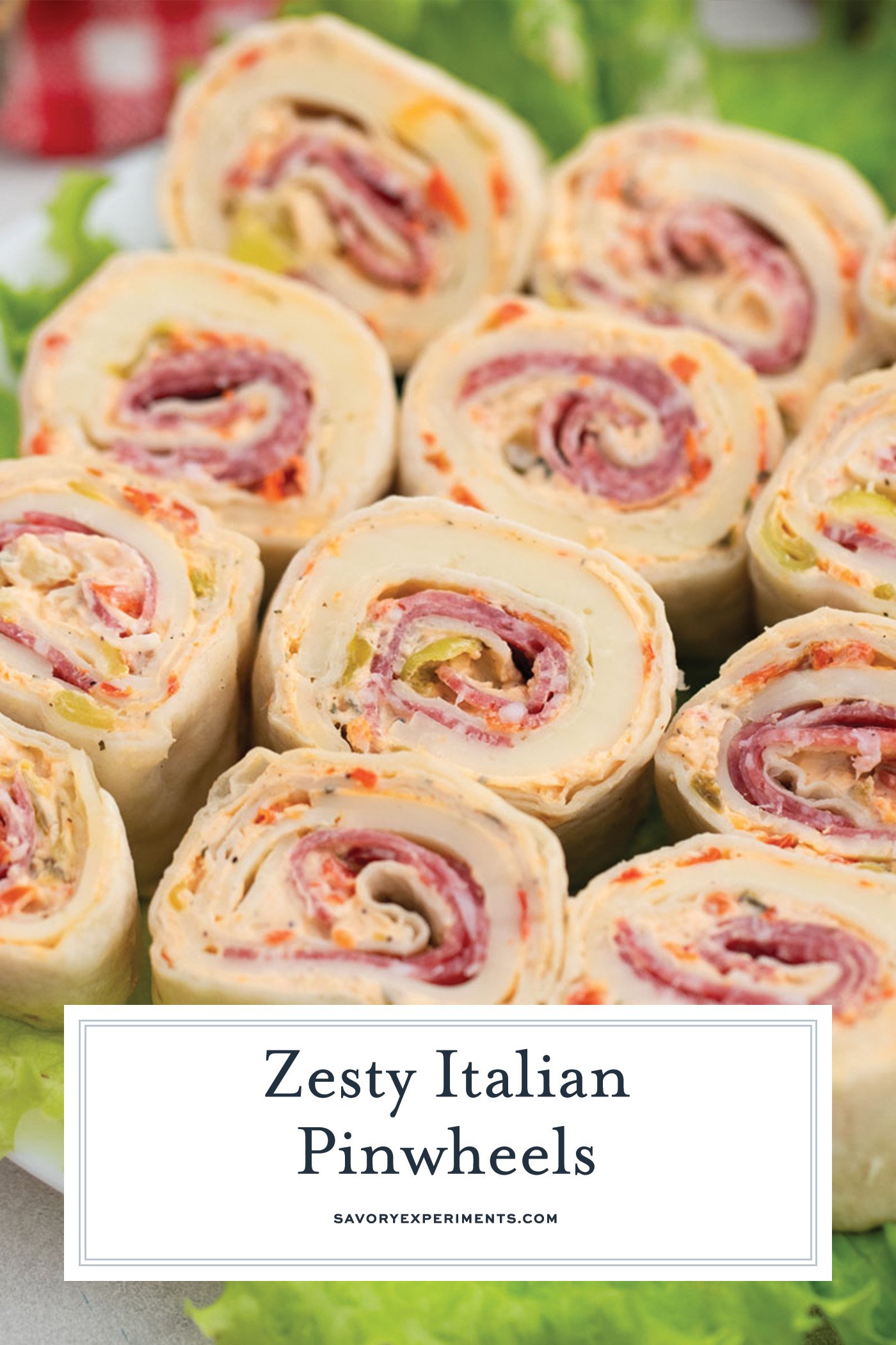 angled shot of platter of italian pinwheels with text overlay for pinterest