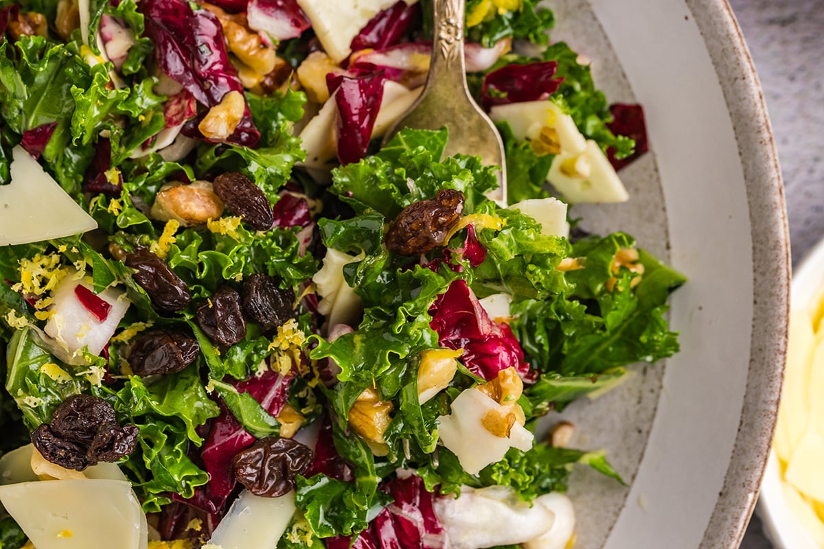 close up overhead shot of bite of kale salad on fork