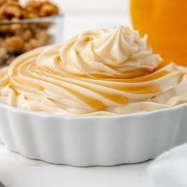 close up maple syrup on mound of white frosting