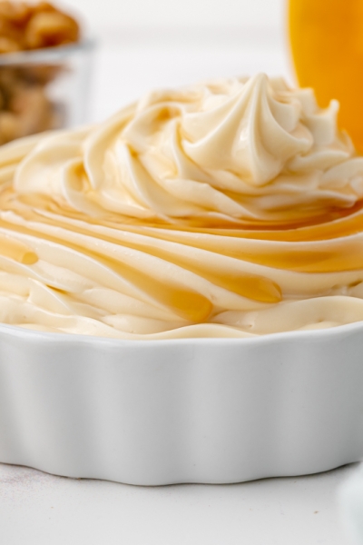 close up maple syrup on mound of white frosting